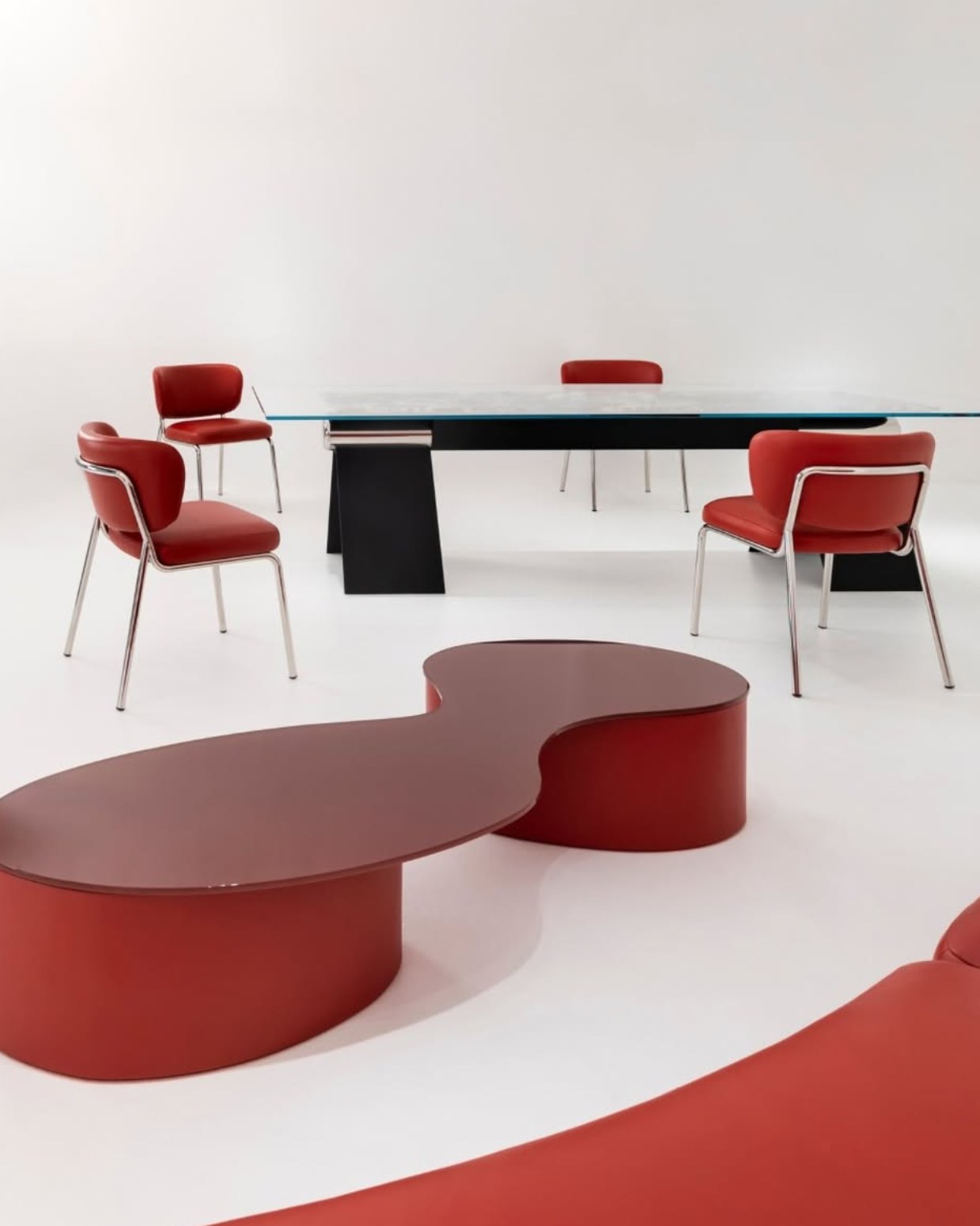 Vertier furniture collection with red sculptural seating and HINGE table